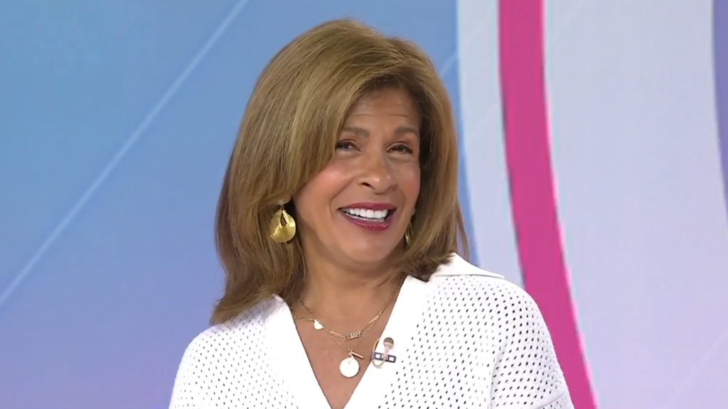 Hoda Kotb smiles coyly and seems to blush.