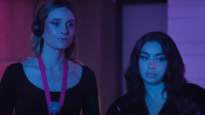 Grace and Charli XCX standing side-by-side in Overcompensating