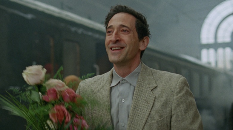 László Tóth carrying flowers in 