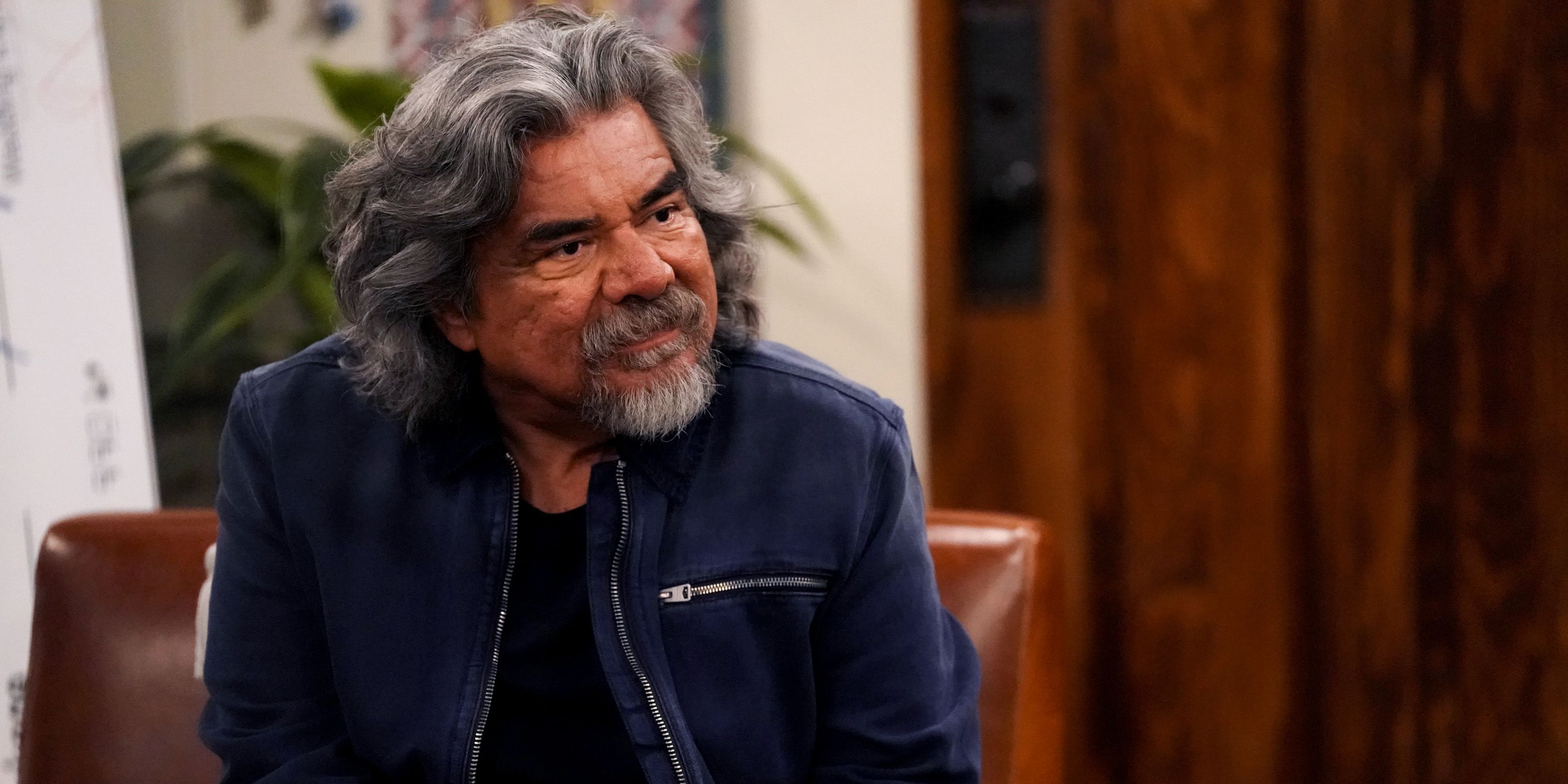 George sitting in a chair and looking ahead in Lopez vs Lopez season 3
