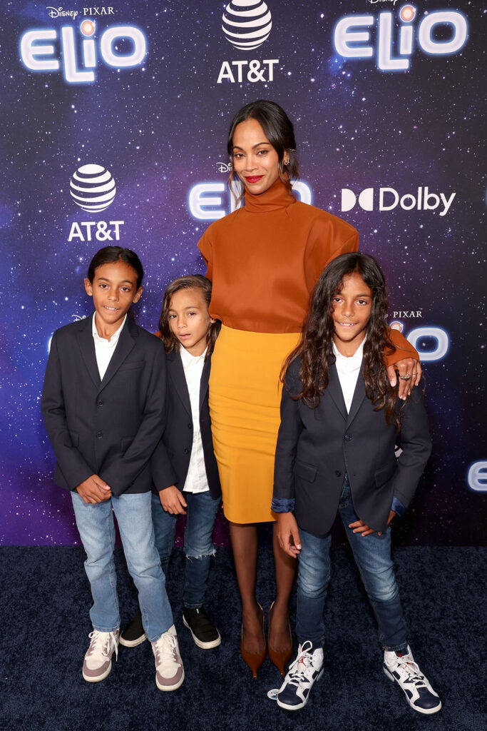 Zoe Saldaña attends the World Premiere of Disney and Pixar's "Elio" in Saint Laurent orange top and yellow skirt.