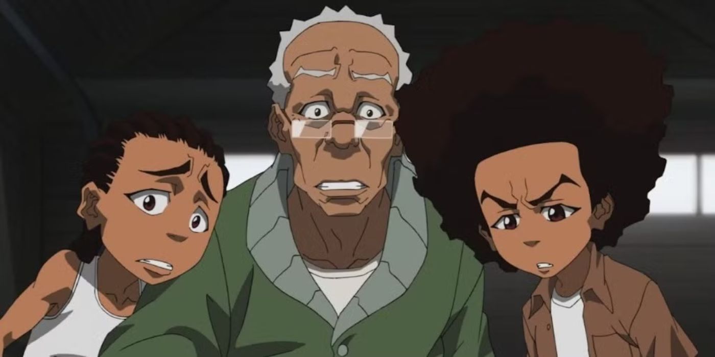 The characters Riley, Granddad, and Huey Freeman huddle together and look worried in The Boondocks. 