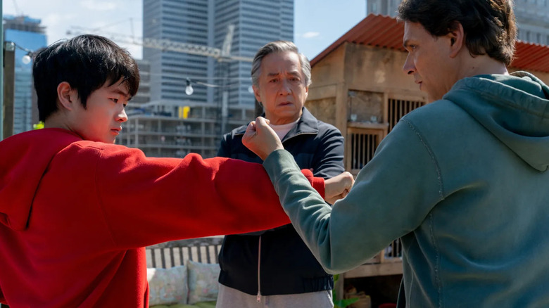 Daniel practicing karate with Li as Mr. Han watches in Karate Kid: Legends