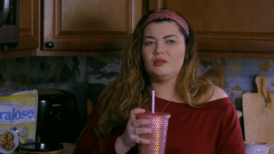 Amber Portwood holds a drink cup in her kitchen.