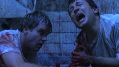 Adam, played by Leigh Whannell and Dr Gordon, played by Cary Elwes in Saw (2004)