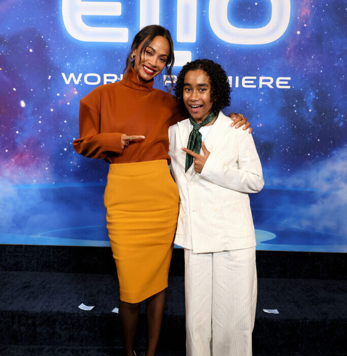 Zoe Saldaña and Yonas Kibreab attend the World Premiere of Disney and Pixar's "Elio" in Saint Laurent orange top and yellow skirt