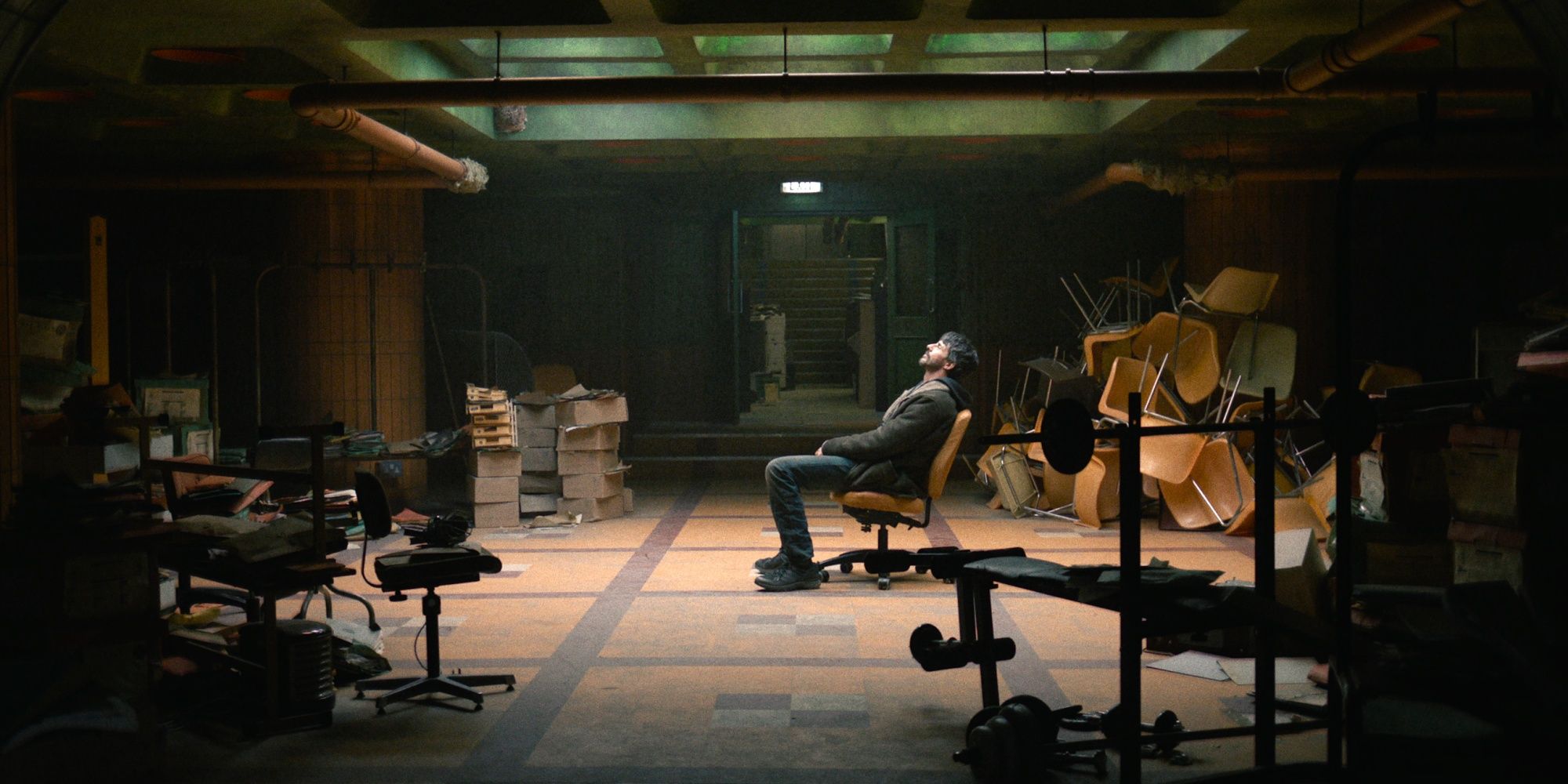 Matthew Goode as DCI Carl Morck sitting in the middle of his basement office, formerly a bathroom, in Dept. Q.